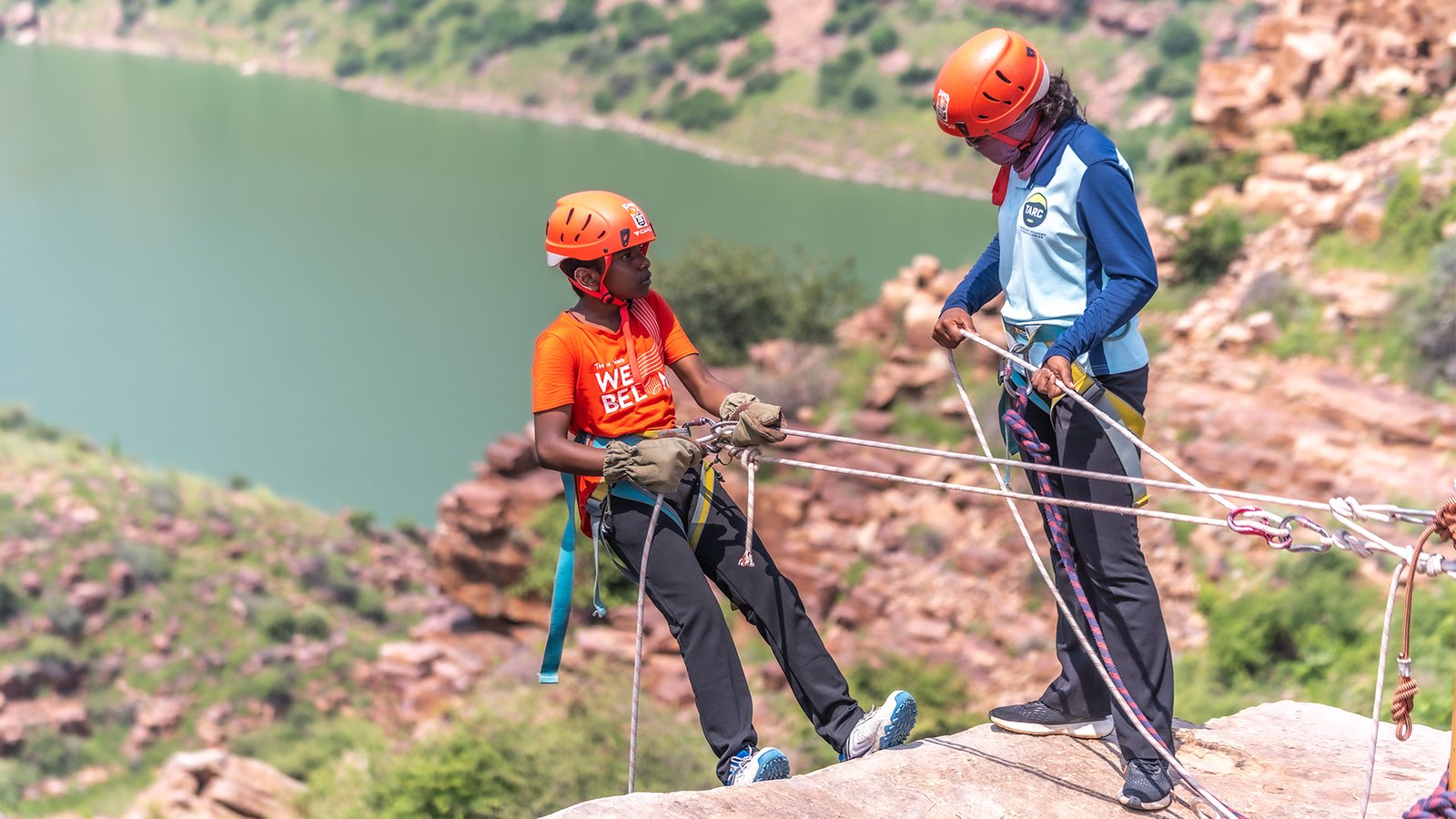 Student rappelling under guidance of ASAAP instructor at Gandikota adventure training program